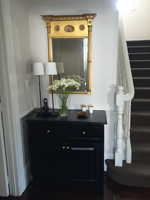 Staircase leading to three bedrooms and two bathrooms upstairs.