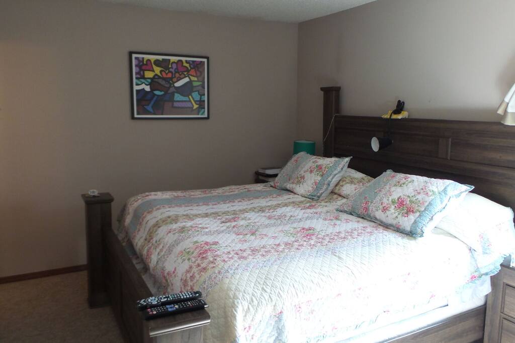 king size bedroom with private 1/2 bathroom