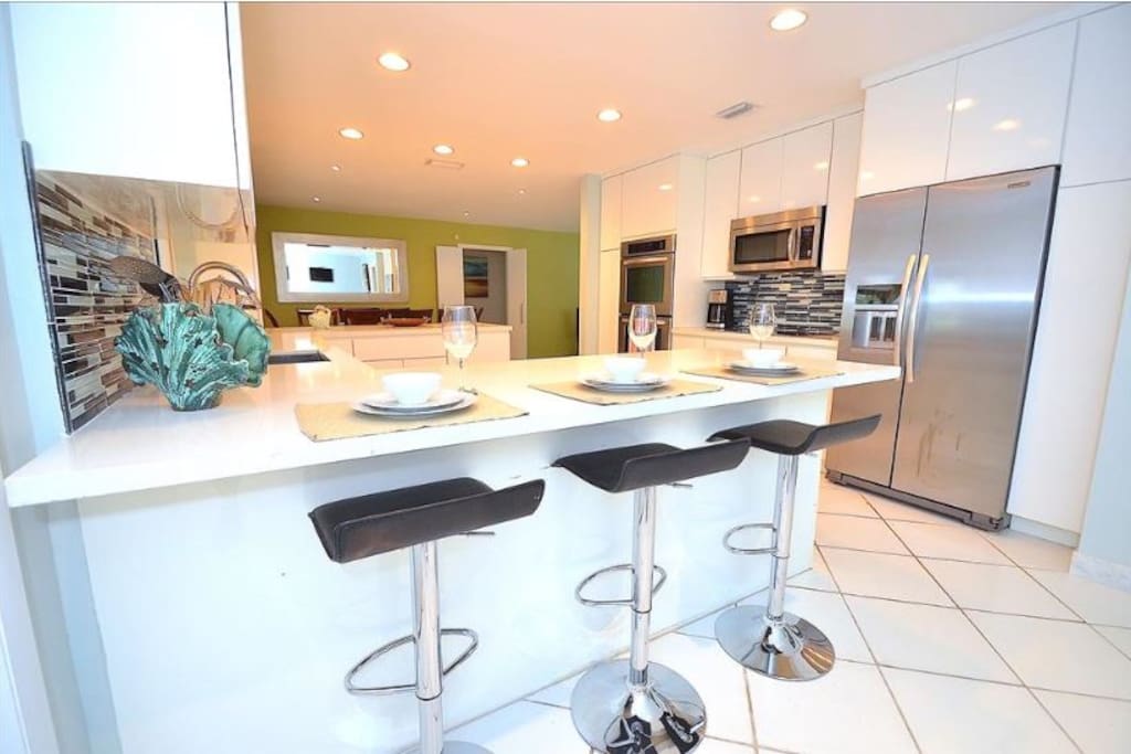 Spacious Open Kitchen (Fully Equipped) Features Quartz Counters (Barstool Dining) + Pool Lounge Views + Access...
