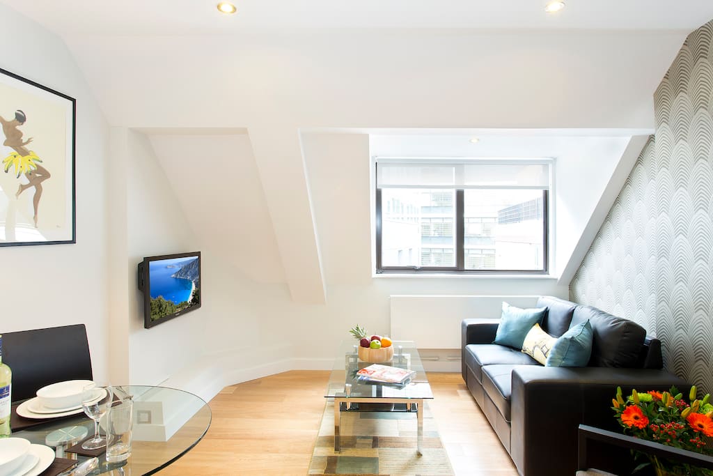 Comfortable Living-room with flat-screen TV and a work/dining table