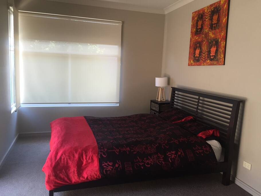 A large bedroom and queen size bed