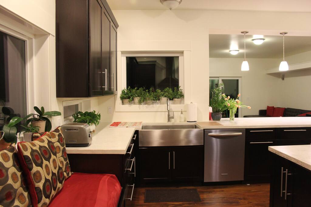There is a pull out trash/recycle bin next to the dishwasher