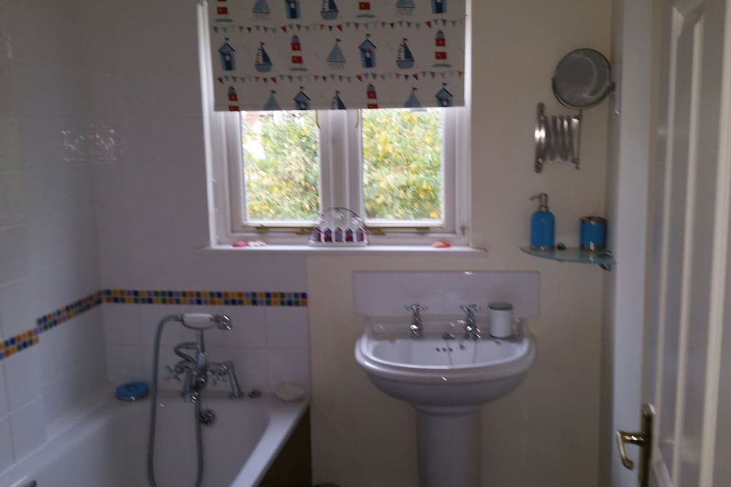 Large family bathroom with towels and toiletries available.