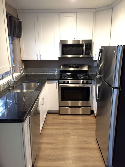 Fully remodeled kitchen with gas stove, granite counters and stainless steel appliances. Microwave, coffee pot, dishes and utensils are also included. Enjoy!