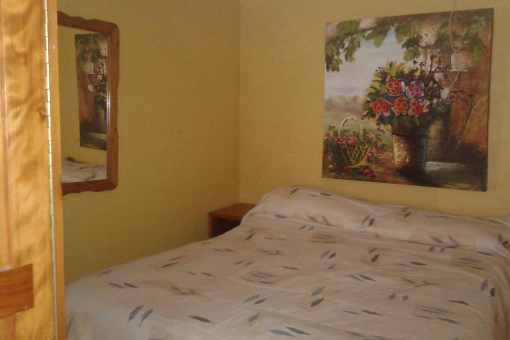 cozy double bed w/great mattress in 1 bedroom apt.A. with private kitchen and bathroom , and private patio with INCREDIBLE VIEW of Volcano and city lights Also have a 2 bedroom and a charming rustic 2 bedroom chalet listed below