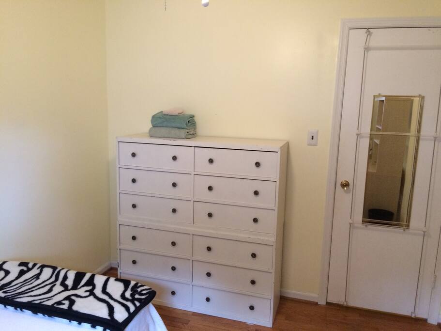 Dresser and mirror in twin bed room