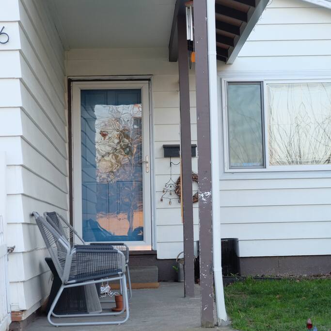 Entrance: Front door and patio chairs.