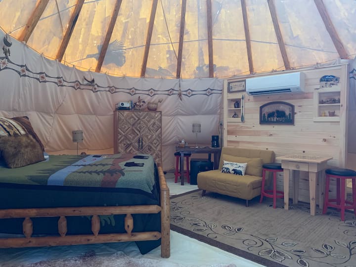 Queen log bed, cabinet containing extra linens and coffee supplies, convertible chair makes into a single bed suitable for young ones