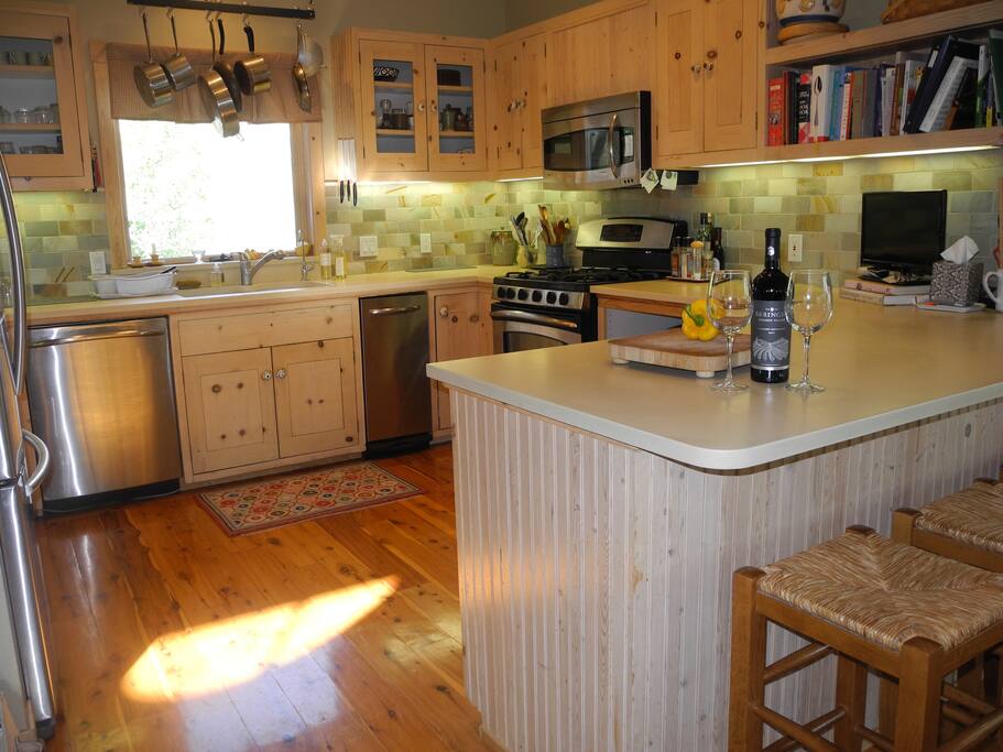 Main level has the light filled kitchen with gas burners, stainless appliances, Cesarstone counters and all you need to cook at home