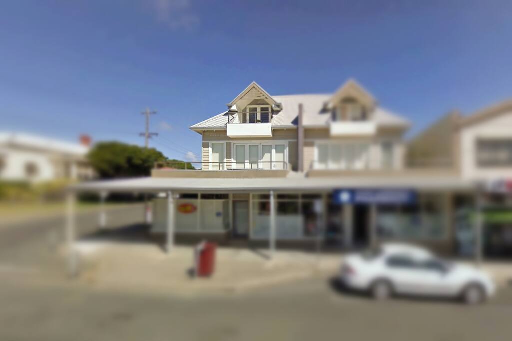 Front of apartment (left one above shops)