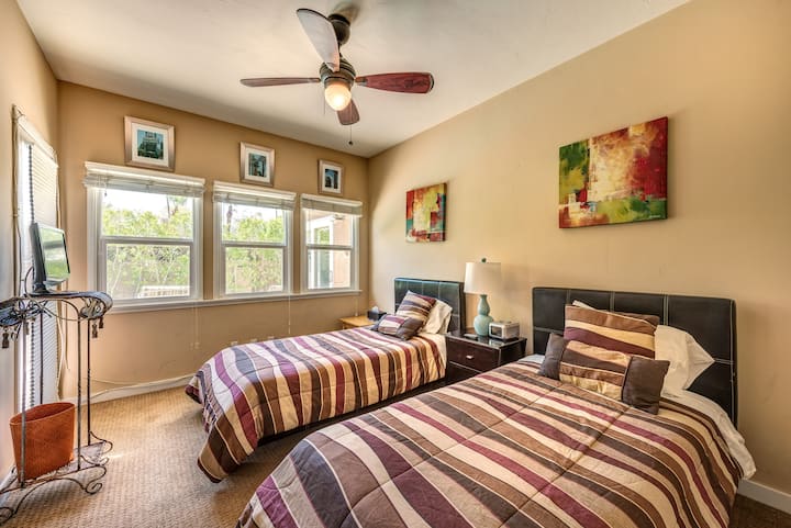 Twin beds guest room opens to pool