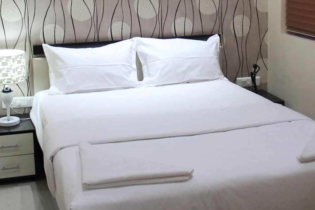 Bedroom view with a queen size bed, attached bathroom, airconditioned