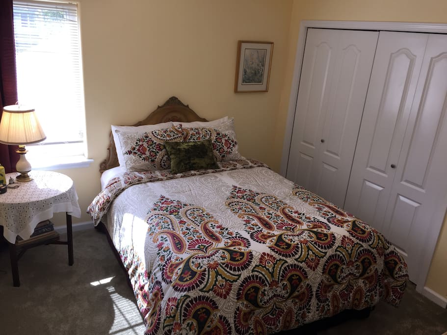 Sunny room facing south with queen bed.