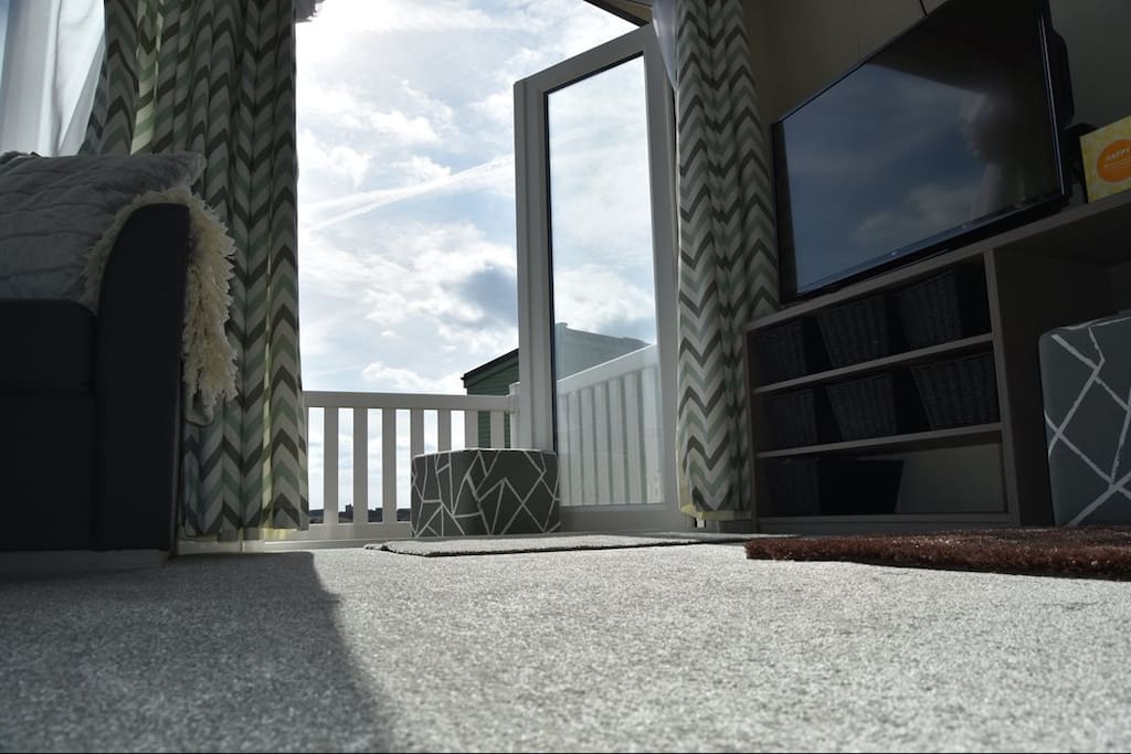Living dining area showing french doors to decking.