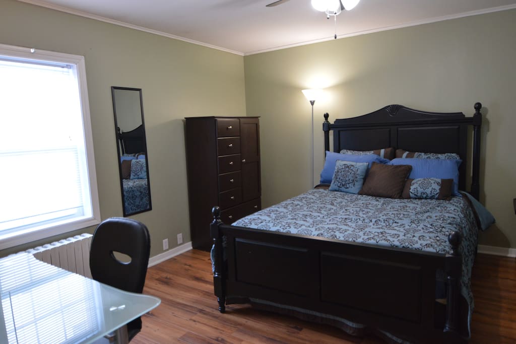Master bedroom has lots of storage and a workdesk with lamp.