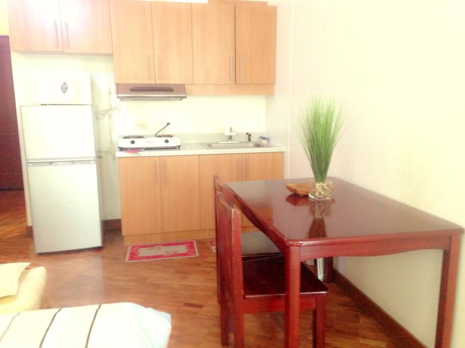Dining Nook - Dining table with two chairs, refrigerator, stove, microwave
