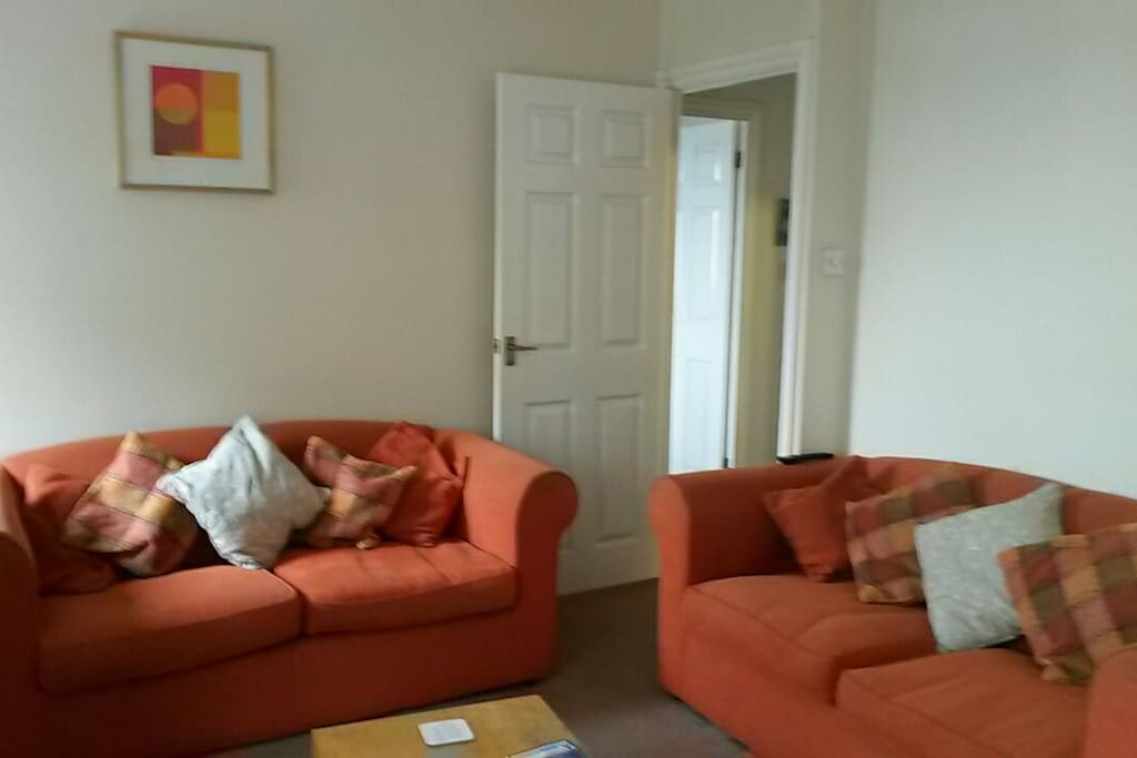 Very large, sunny living room with two sofas overlooking Twickenham Stadium