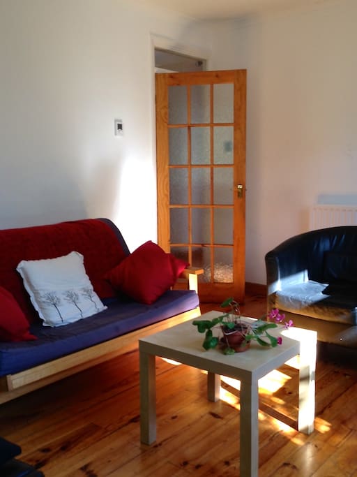 Light and comfortable sitting room with TV, stereo system and desk