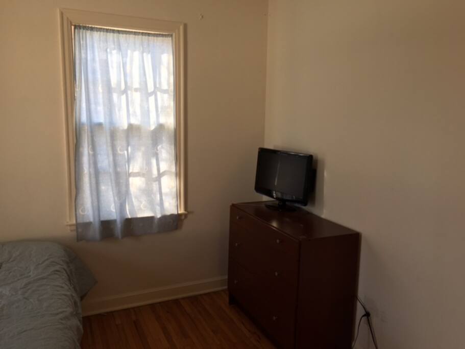 The dresser near the window
