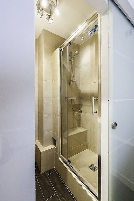 Photo of shower. This photo is from a twin apartment and the shower in my studio is very very similar in every way (except the lamp in the ceiling)