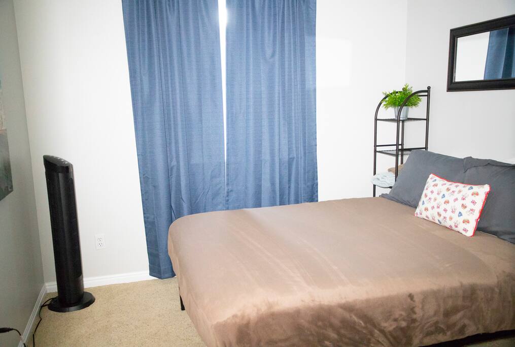 This private room features a comfortable queen-size mattress, an oscillating fan, reading lamp, fake plant, closet space with hangers, and blackout curtains.
Additional options: down comforter, space heater