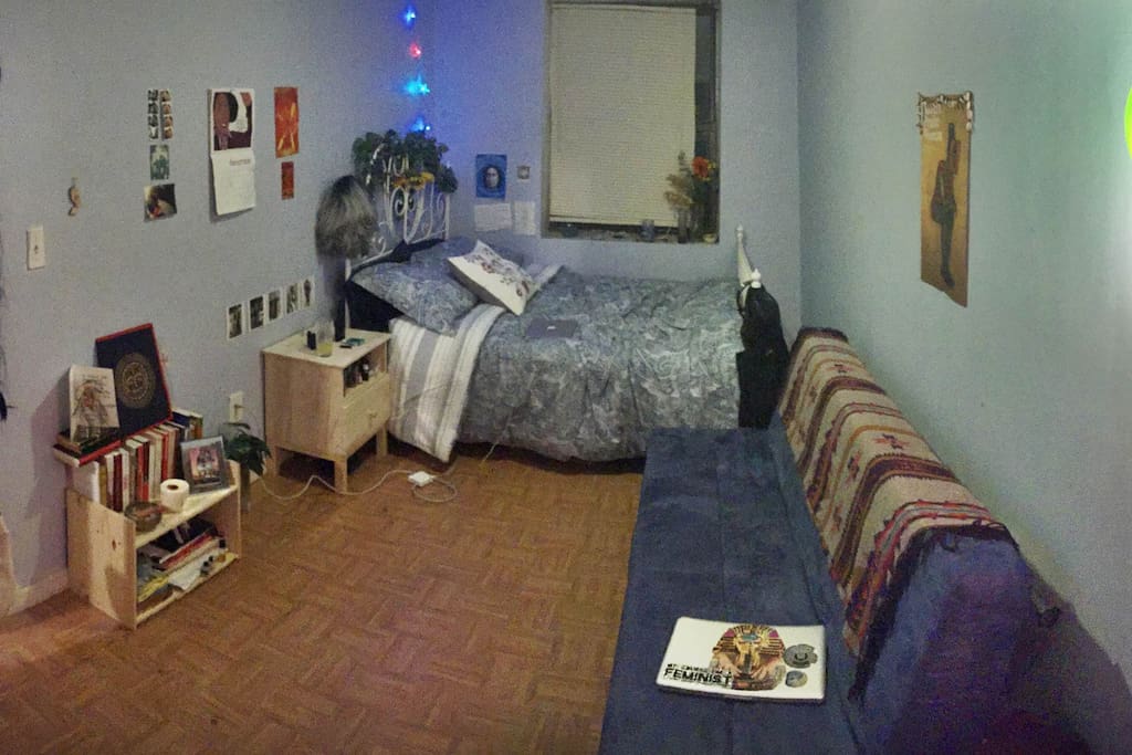 Spacious room, lavender walls, futon bed, futon couch, lots of natural light