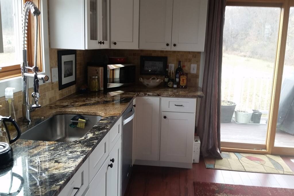 Kitchen area, back deck with grill through doors.