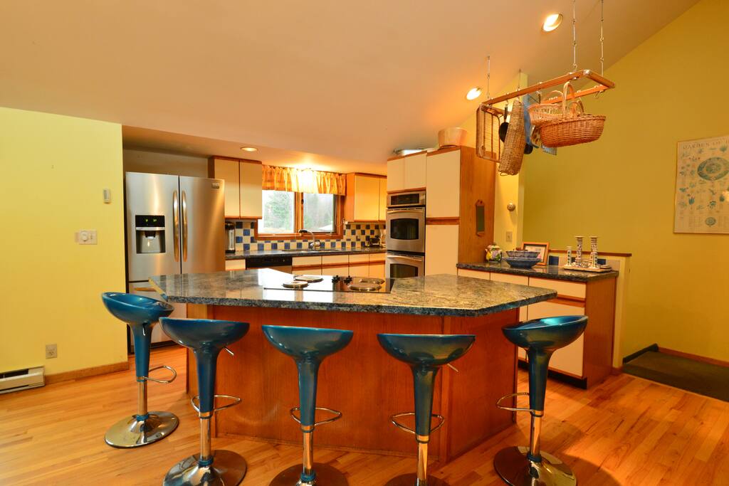 Kitchen with two ovens and a full complement of cookware.