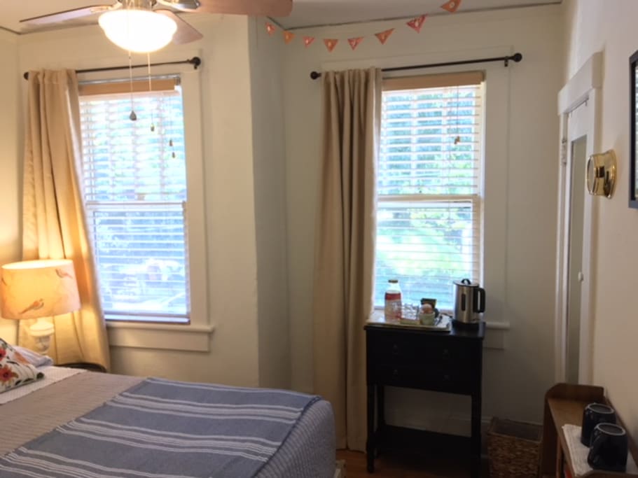 The room is complete with room darkening curtains, electric teapot, and large closet with luggage rack.