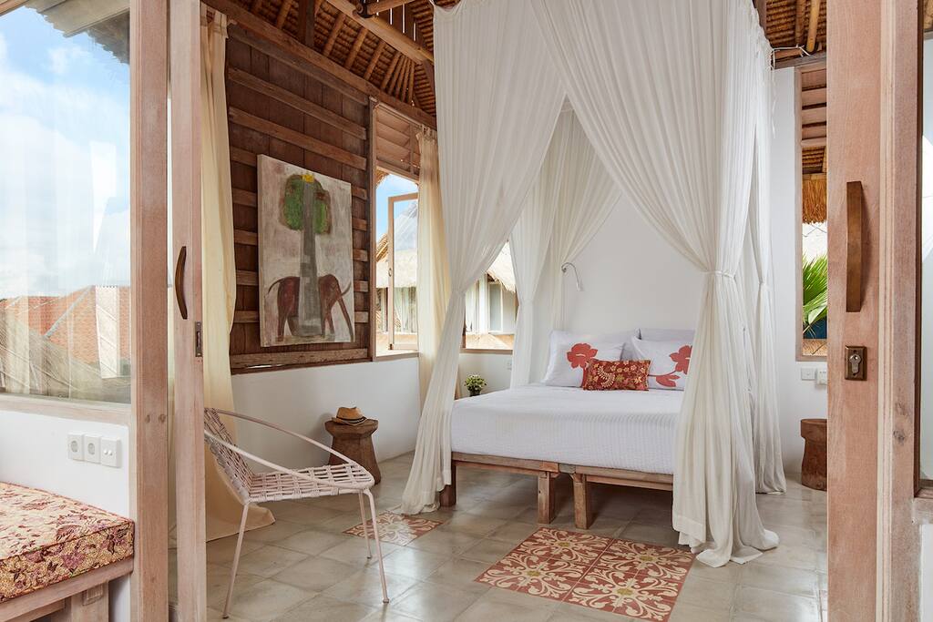 View of queen size bed and old teak panels.
