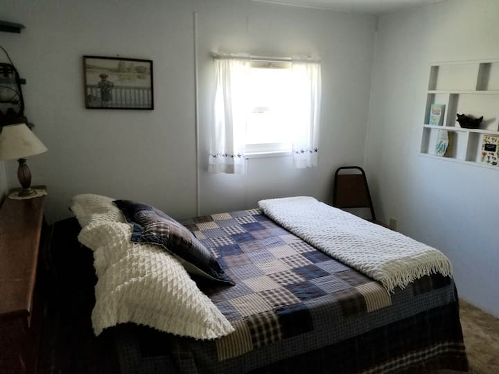 Longspur bedroom with a double bed.