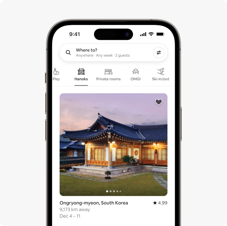 A laptop and a phone show the Airbnb homepage with two rows of homes from a new Airbnb Winter Release category called Hanoks, which features traditional 14th-century South Korean homes made of natural materials.