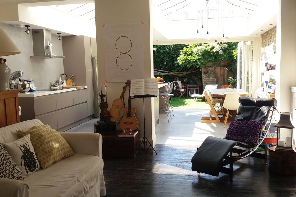 The kitchen and family room are open space. Here you will find the TV (hidden in a cupboard) a piano, and a guitar.