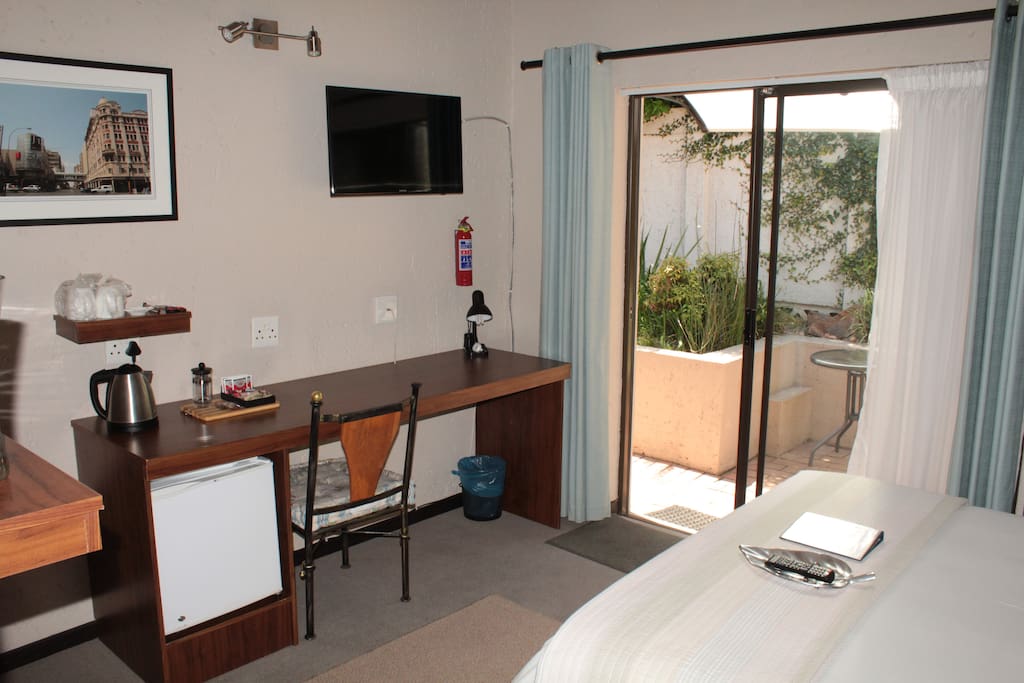 Room 4, fridge and desk, sliding door to patio