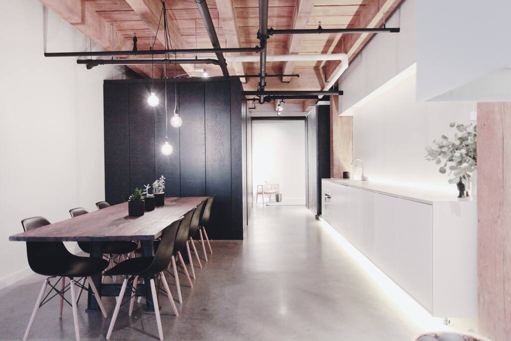 Large spacious heritage loft with high ceilings and modern furnishings.