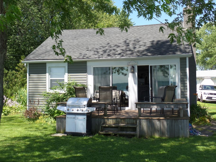 Adorable exterior with front deck and BBQ