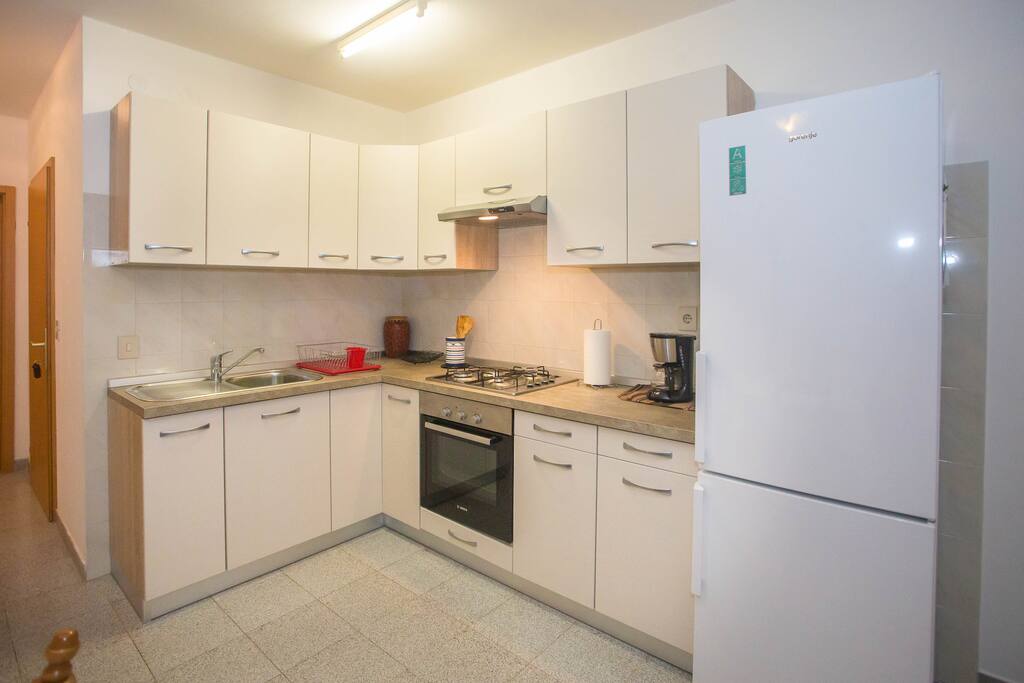 Kitchen with stove, oven, refrigerator and utensils