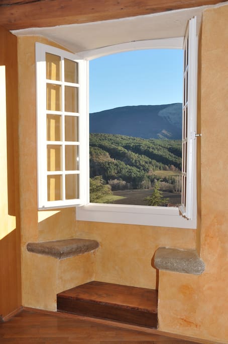 Living room window with ancient stone seat, facing south