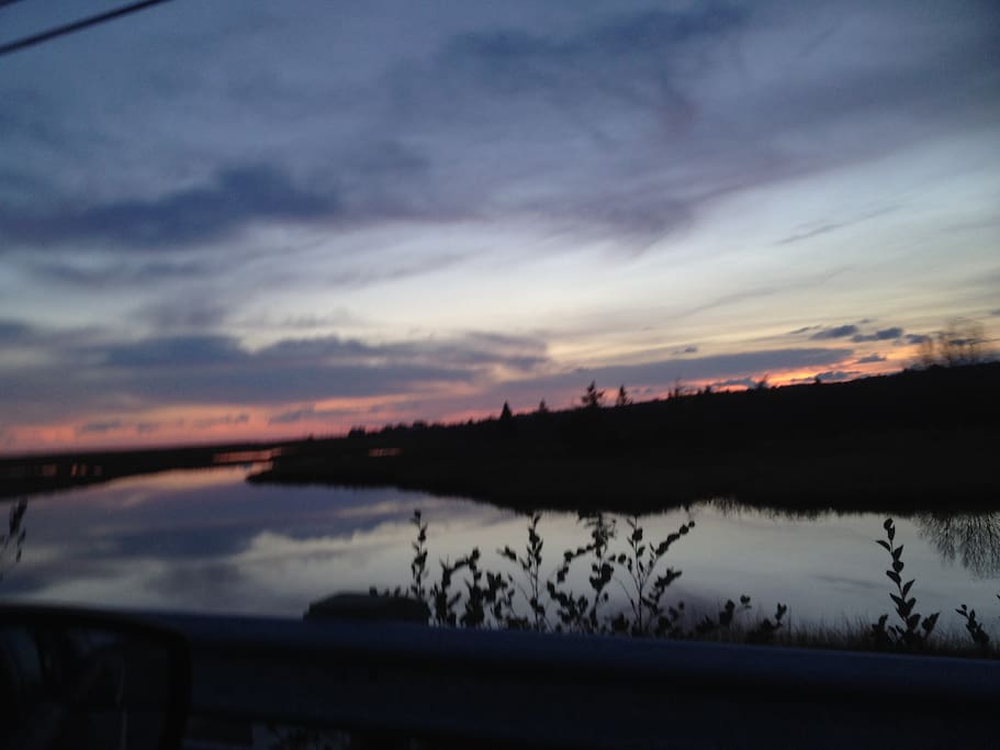 Sunset on the Mavillette River from bridge, next to house.