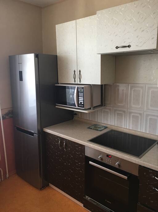 Kitchen with microwave, fridge, oven