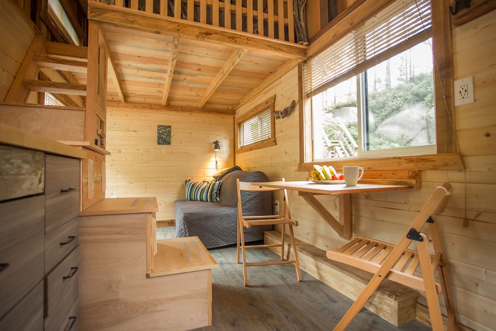 Its actually pretty spacious in there. Living room with a futon/sofa and small table. Dining table and chairs can be tucked away for more space if needed.