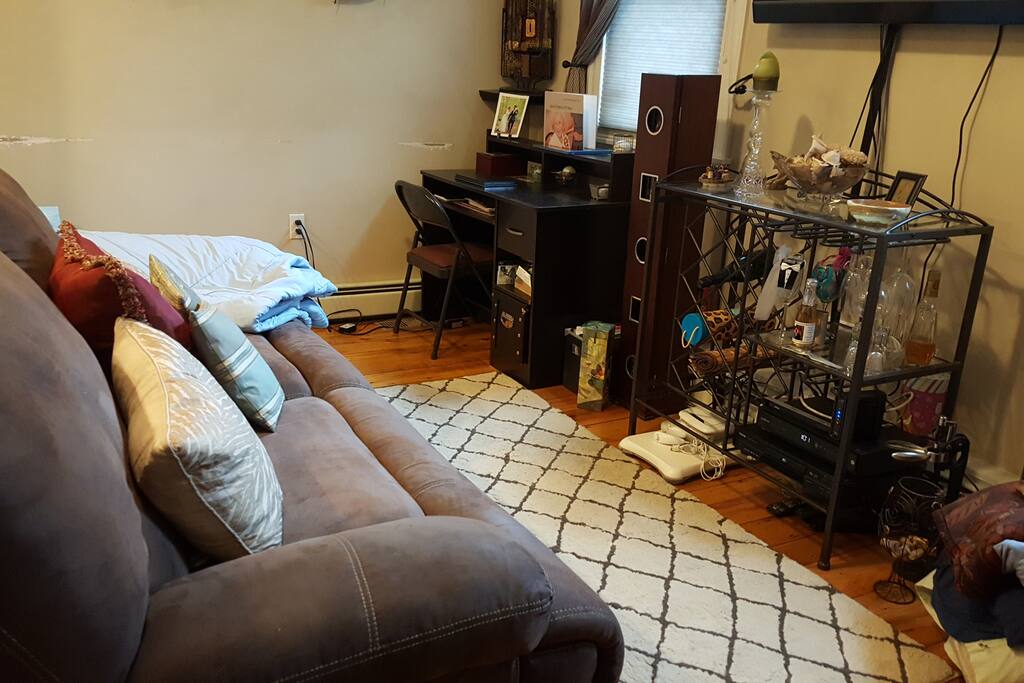 Living room with power reclining sofa that can lay almost flat and a desk area