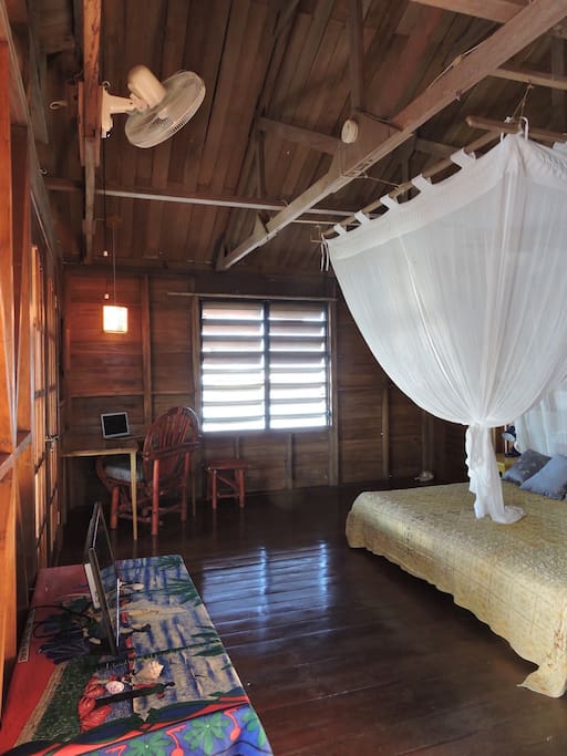 This is the largest guest room in the home and is situated on the front with a direct sea breeze most nights. There is NO AC in the room only fans and ocean breezes.