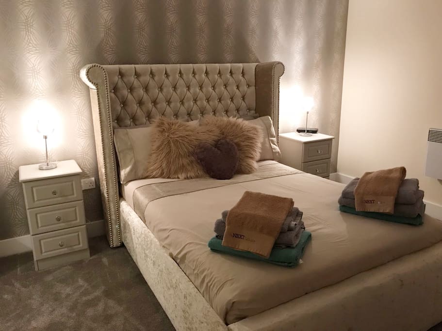 Master bedroom with luxurious bed and en suite