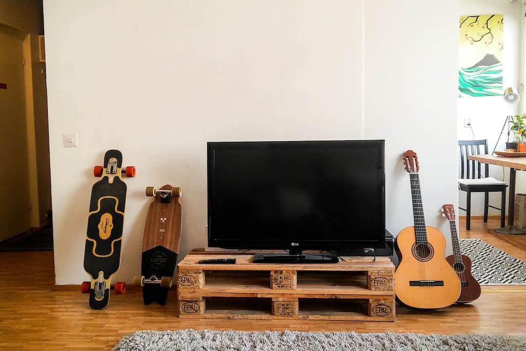 Flat-screen TV. We're most probably using the longboards ourselves but you can usually find the guitar and the uke here. Feel free to give them a play!
