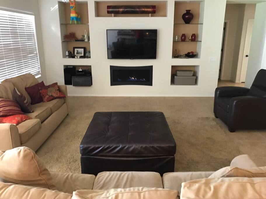 Living room with gas fireplace under the tv.