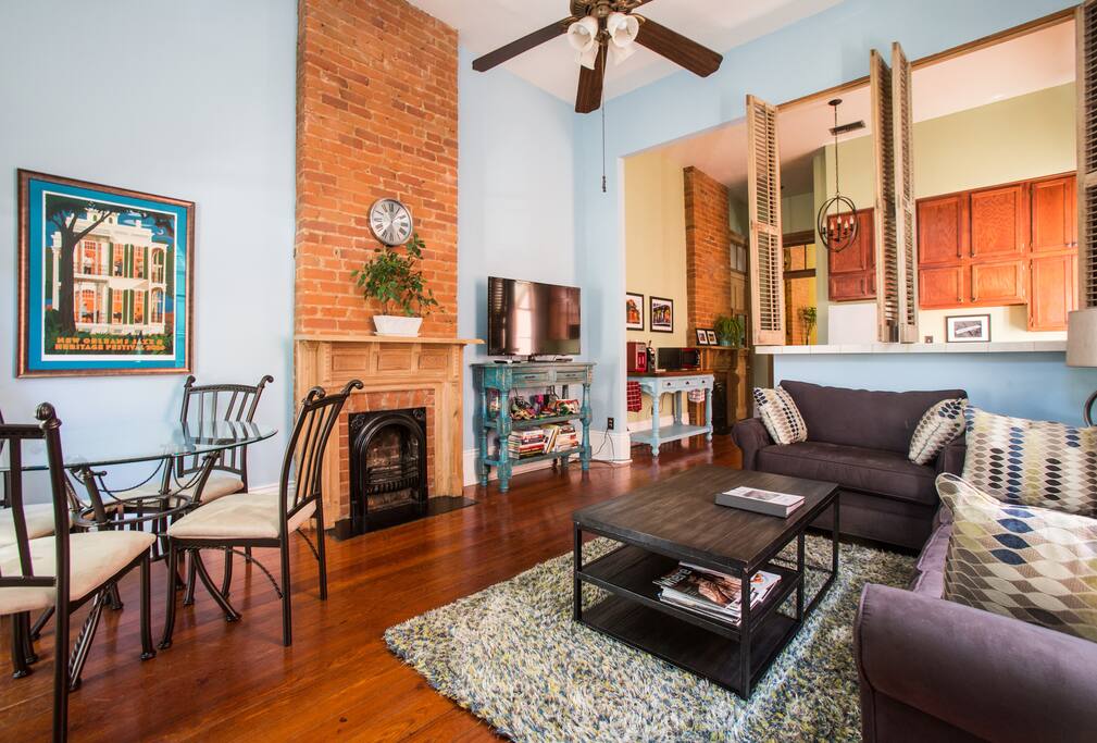 View of the living room and kitchen from the entrance to the apartment. 50-inch television has over 500 channels of Direct TV.