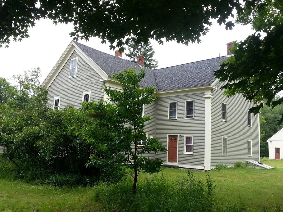 Back Side of our home set on 8 acres of field and forest.