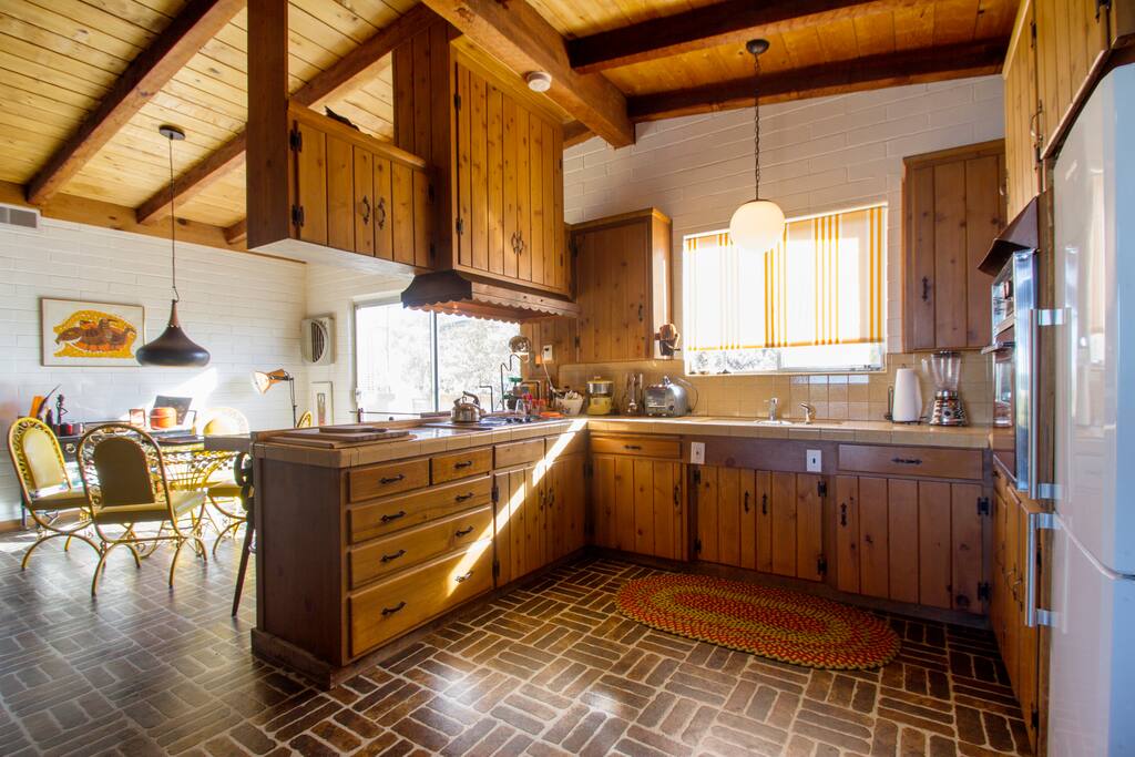 The kitchen opens onto the light-filled dining area.