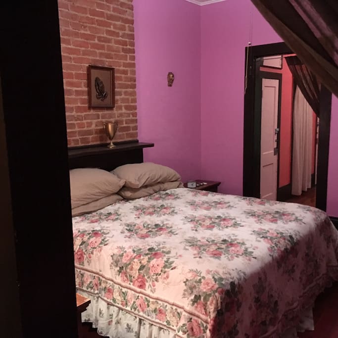 The next room is the first bedroom - in resplendent purple tones...